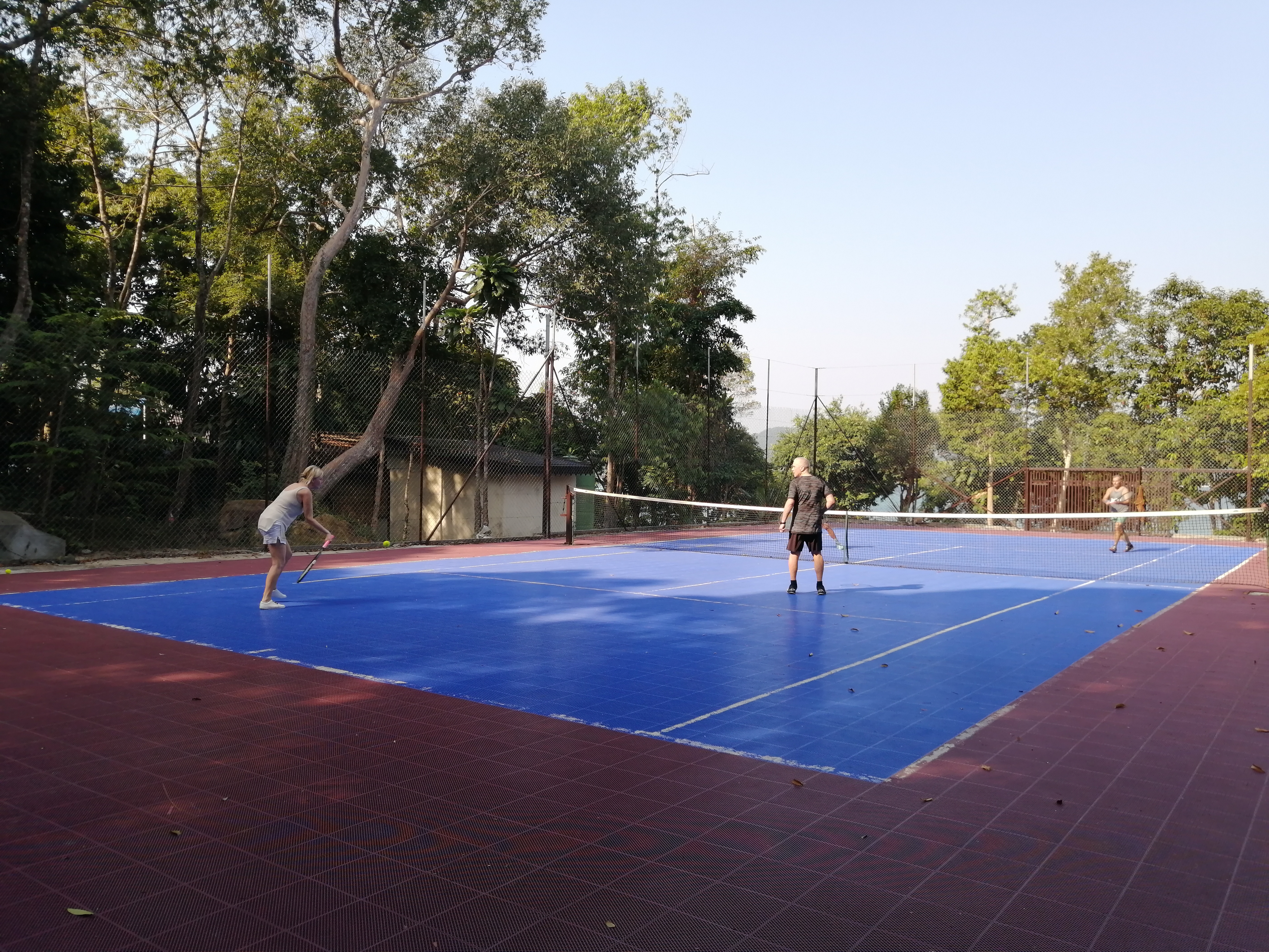 Doubles tennis on the court at Samloem Laguna Resort